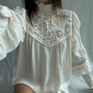Cream lace blouse with ruffled sleeves and high neck